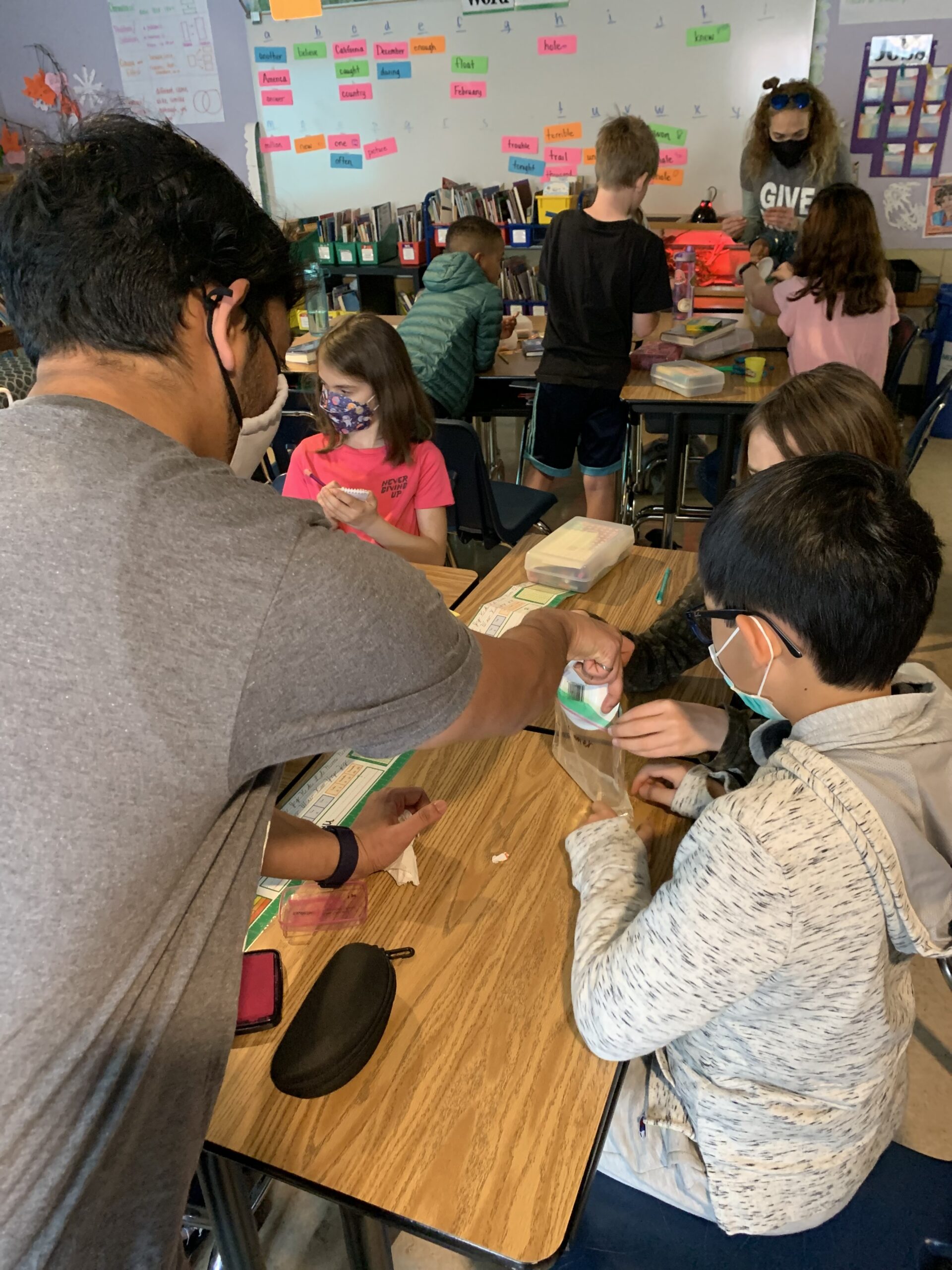 scientist helping student with experiment